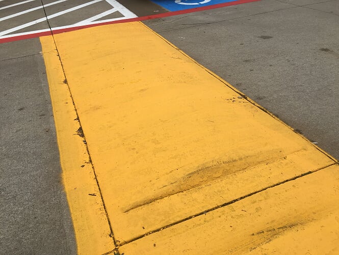 Yellow Speed Bump In Parking Lot